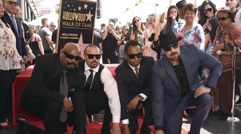 Sen Dog, from left, DJ Muggs, Eric "Bobo" Correa and B-Real, of hip-hop group Cypress Hill, atop their new Hollywood Walk of Fame star on April 18, 2019. CHRIS PIZZELLO/INVISION/AP