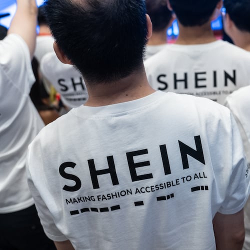 A logo of fast-fashion retailer Shein is seen on the t-shirt at the listing ceremony in Hong Kong, Tuesday, Sept. 1, 2026. (AP Photo/Chan Long Hei)
