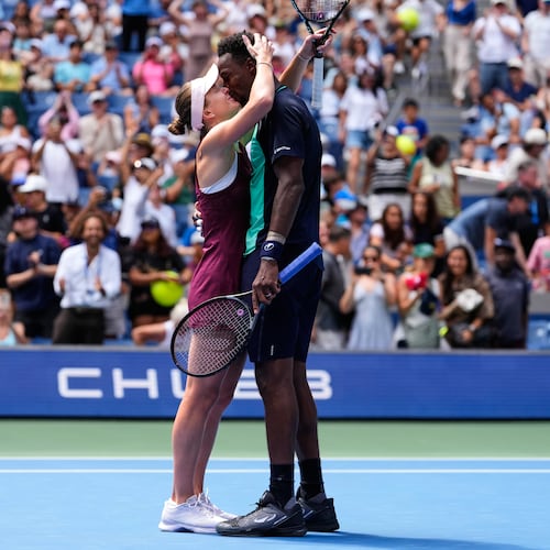 Elina Svitolina, of Ukraine, left, and Gael Monfils, of France, kiss after winning a mixed doubles match at the U.S. Open tennis championships, Tuesday, Aug. 25, 2026, in New York. (AP Photo/Yuki Iwamura)