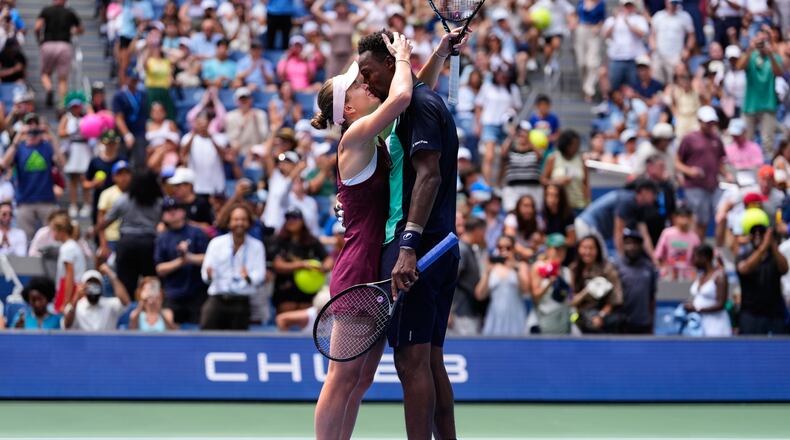 Elina Svitolina, of Ukraine, left, and Gael Monfils, of France, kiss after winning a mixed doubles match at the U.S. Open tennis championships, Tuesday, Aug. 25, 2026, in New York. (AP Photo/Yuki Iwamura)