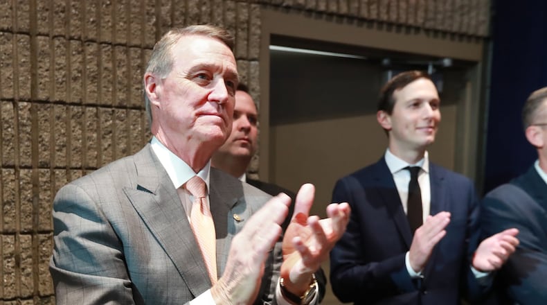 U.S. Sen. David Perdue applauds President Donald Trump during his speech at the Black Voices for Trump Coalition Rollout in November in Atlanta. Curtis Compton/ccompton@ajc.com