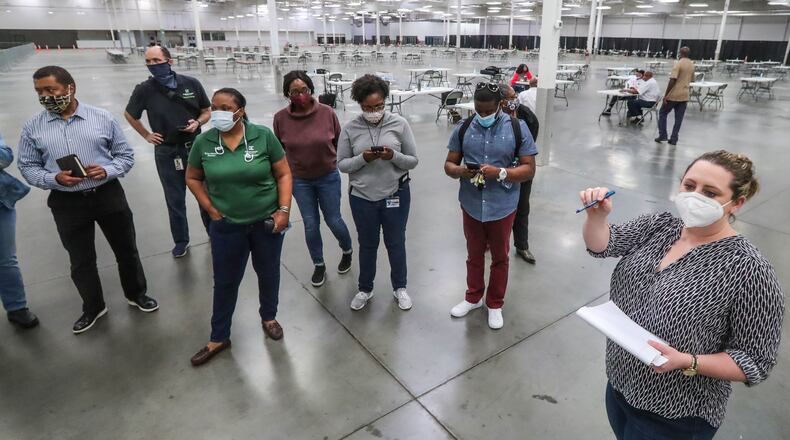 November 13, 2020 Stonecrest: DeKalb County officials joined with the City of Stonecrest officials for a walkthrough Friday, Nov. 13, 2020 of the vote counting facility at the former Sam’s Club in Stonecrest, where it plans to start its part of the recount at 7 a.m. Saturday. Officials said the facility which was used as an early voting site for the election provides more space and allows for better social distancing than would be possible at the county’s elections office off Memorial Drive. Joe Biden led Donald Trump by 14,000 votes as of Friday morning. The cost of Georgia recount six-day recount isn’t known, but initial estimates from DeKalb County indicate it might be pricey. DeKalb officials said Friday the recount will cost about $180,000, including $147,000 in pay, $20,000 for food and beverages, and $12,000 for personal protective equipment and other coronavirus-related precautions. The numbers are preliminary and may change, according to DeKalb. (John Spink / John.Spink@ajc.com)