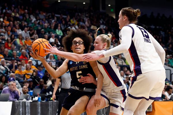 Notre Dame guard Olivia Miles (5) is fouled by TCU guard Hailey Van Lith (10) as she drives to the basket during the first half in the Sweet 16 of the NCAA college basketball tournament, Saturday, March 29, 2025, in Birmingham, Ala. (AP Photo/Butch Dill)