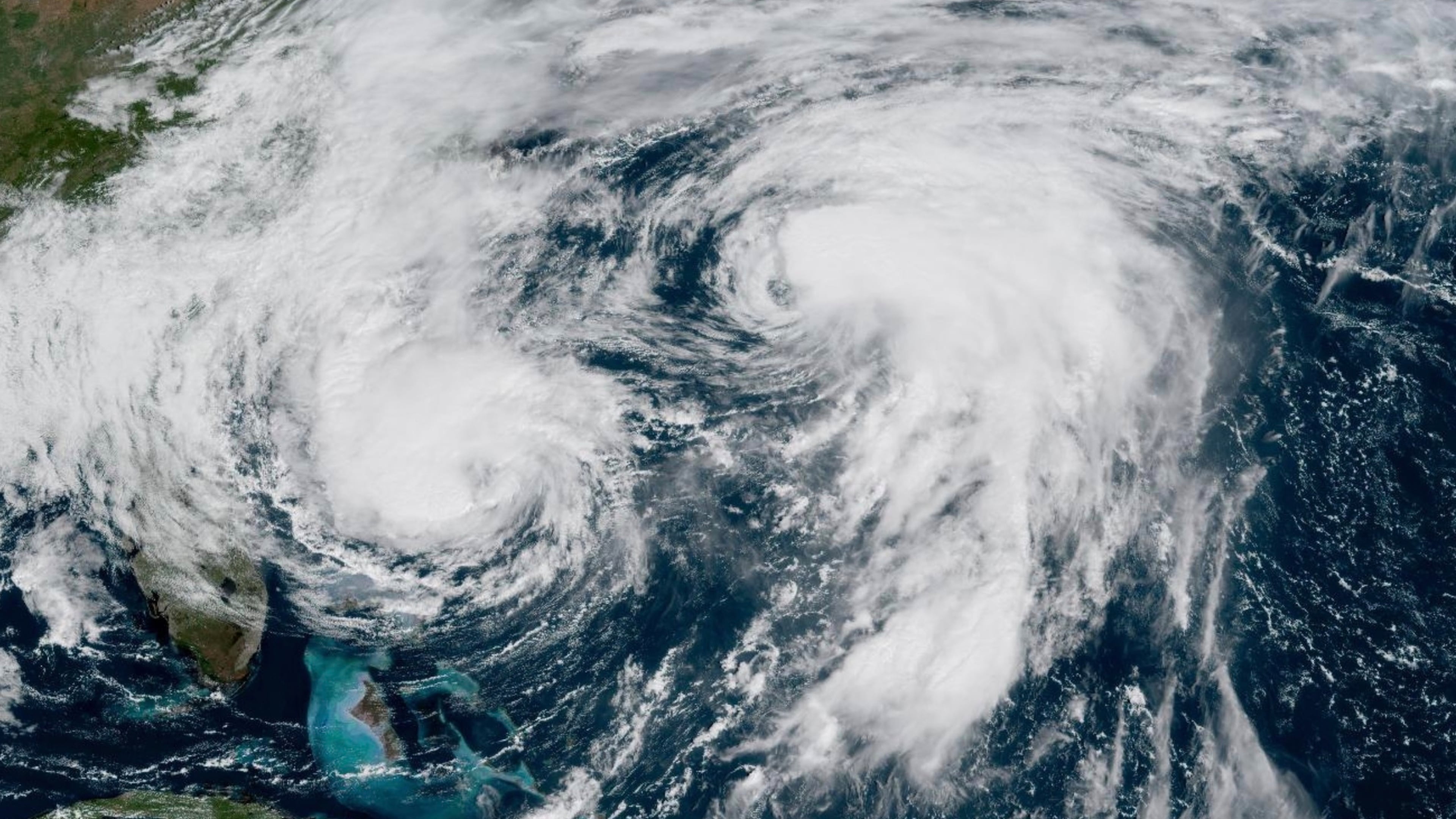 This GOES-19 GeoColor satellite image taken Tuesday, Sept. 30, 2025 and provided by NOAA, shows weather systems in the Atlantic Ocean, Hurricane Imelda, left, and Hurricane Humberto at right. (NOAA via AP)