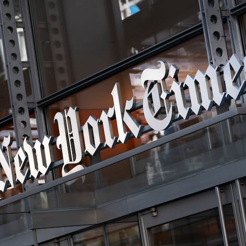 FILE - A sign for The New York Times is displayed above the entrance to its building in New York on May 6, 2021. (AP Photo/Mark Lennihan, File)