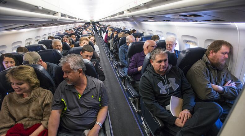 Passengers on a flight in Las Vegas. (Joe Giron/The New York Times)