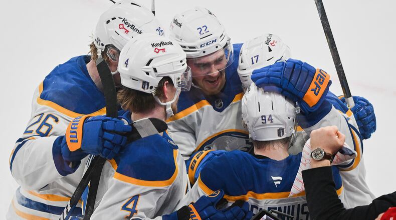 Buffalo Sabres' Konsta Helenius (94) celebrates with teammates after scoring against the Montreal Canadiens during the second period of Game 6 in a second-round NHL hockey Stanley Cup playoff series in Montreal, Saturday, May 16, 2026. (Graham Hughes/The Canadian Press via AP)