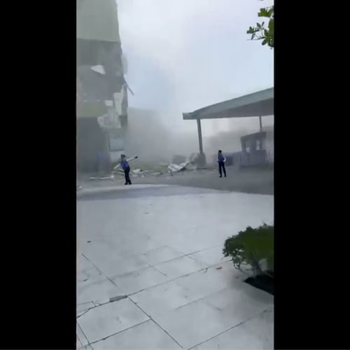 This image from a video shows dust and debris outside a building after a powerful earthquake in General Santos city on the island of Mindanao, Philippines Monday, June 8, 2026. (Ernesto Torres Jr via AP)
