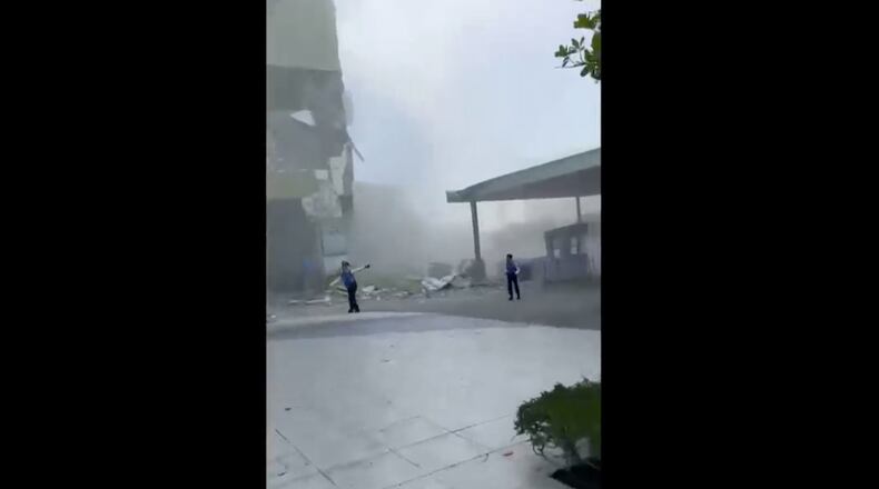 This image from a video shows dust and debris outside a building after a powerful earthquake in General Santos city on the island of Mindanao, Philippines Monday, June 8, 2026. (Ernesto Torres Jr via AP)