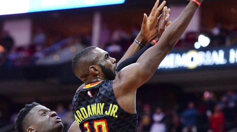 Atlanta Hawks guard Tim Hardaway Jr. (10) scores in front of Houston Rockets center Clint Capela during the second half of an NBA basketball game Thursday, Feb. 2, 2017, in Houston. (AP Photo/George Bridges)