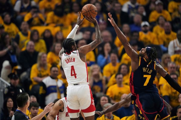 Houston Rockets guard Jalen Green (4) shoots a 3-point basket over Golden State Warriors guard Buddy Hield (7) during the first half of Game 4 of an NBA basketball first-round playoff series Monday, April 28, 2025, in San Francisco. (AP Photo/Godofredo A. Vásquez)