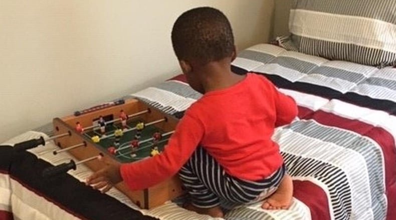 A boy plays on the bed at one of Family Promise’s host congregations. CONTRIBUTED