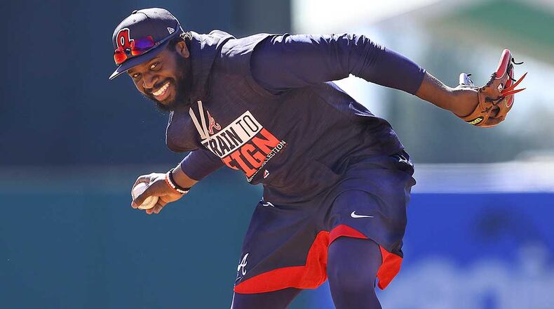 Atlanta Braves infielder Brandon Phillips fields a grounder at the team's spring training facility in Lake Buena Vista, Fla.
