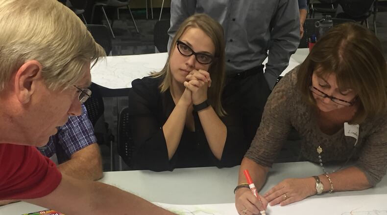 Kelsey Waidhas (center) listens to Dick Hardy (far left) make traffic suggestions specific to Sandy Springs as Linda Reisman (far right) takes notes during a North Fulton Comprehensive Transportation forum on Thursday, Sept. 29.