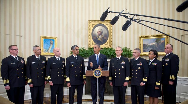 WASHINGTON, DC - SEPTEMBER 24: U.S. President Barack Obama meets with members of the Public Health Service Commissioned Corps (PHS CC) after signing a citation awarding the Presidential Unit Citation to PHS CC members in the Oval Office at The White House September 24, 2015 in Washington, D.C. Members of the PHS CC had participated in the Ebola containment efforts in West Africa. (Photo by Rod Lamkey-Pool/Getty Images)