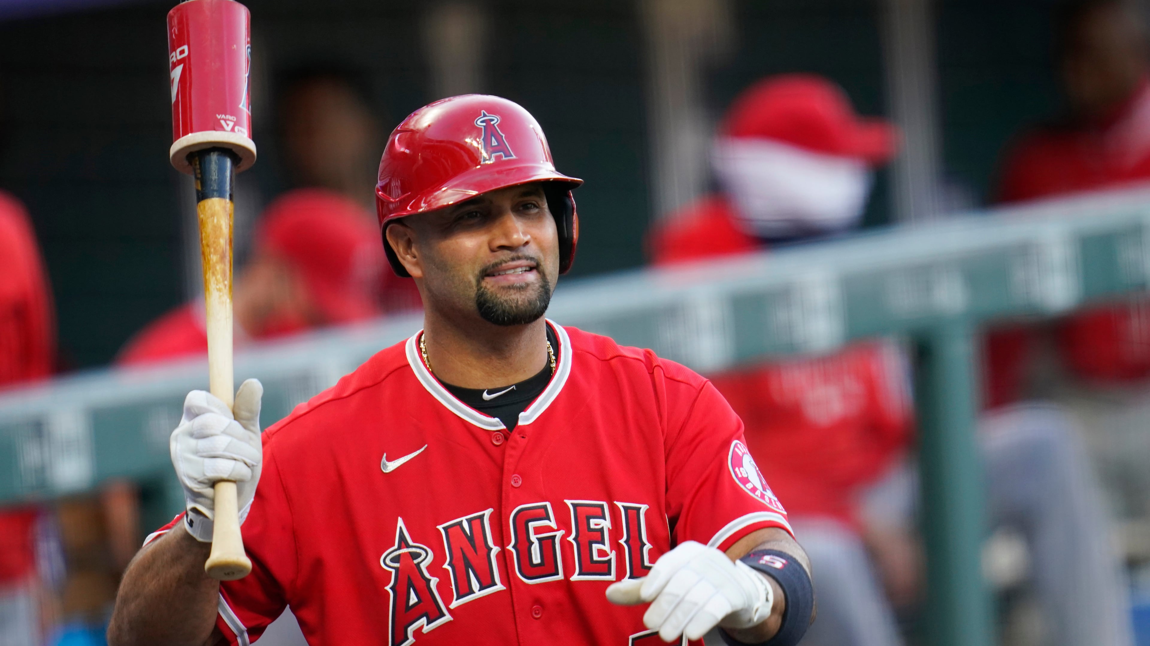FILE - Los Angeles Angels designated hitter Albert Pujols waves to players in the Colorado Rockies dugout in the second inning of a baseball game, Sept. 12, 2020, in Denver. (AP Photo/David Zalubowski, File)