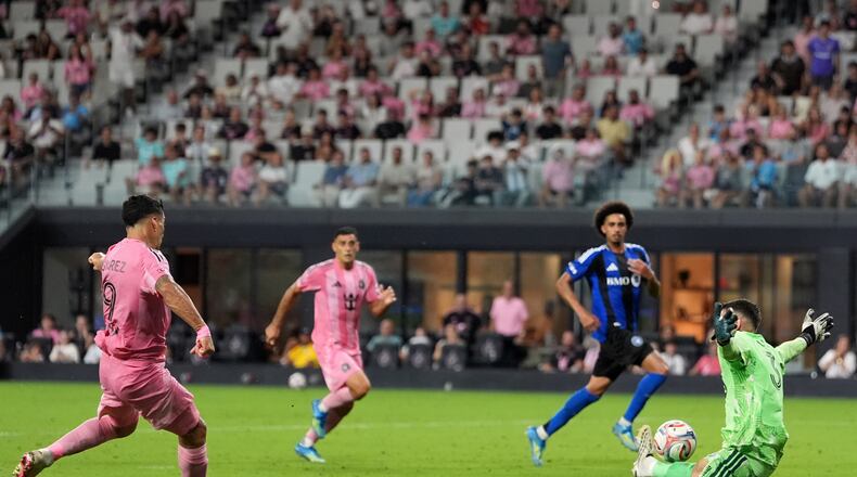 Inter Miami forward Luis Suarez scores his side's fourth goal past CF Montreal goalkeeper Thomas Gillier (31) during the second half of an MLS soccer match, Saturday, Aug. 29, 2026, in Miami. (AP Photo/Rebecca Blackwell)