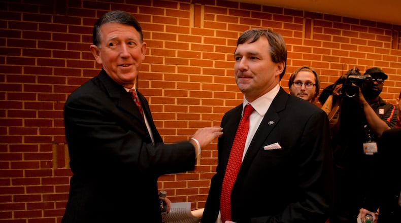 December 7, 2015 Athens, GA: Kirby Smart, right, was given a "Go get em" and a pat on the back by UGA Director of Athletics Greg McGarity before Smart was introduced as the new coach of the University of Georgia during a press conference Monday December 7, 2015 Smart was a former UGA player and coach. Smart replaced Mark Richt after 15 seasons at the helm of the Bulldogs. BRANT SANDERLIN/BSANDERLIN@AJC.COM