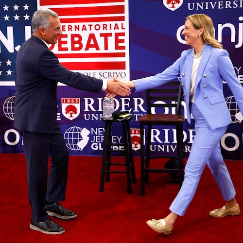 FILE - Republican candidate Jack Ciattarelli, left, shake hands with Democratic candidate for governor Mikie Sherrill, right, before a gubernatorial debate Sept. 21, 2025, in Lawrenceville, N.J. (AP Photo/Noah K. Murray, File)
