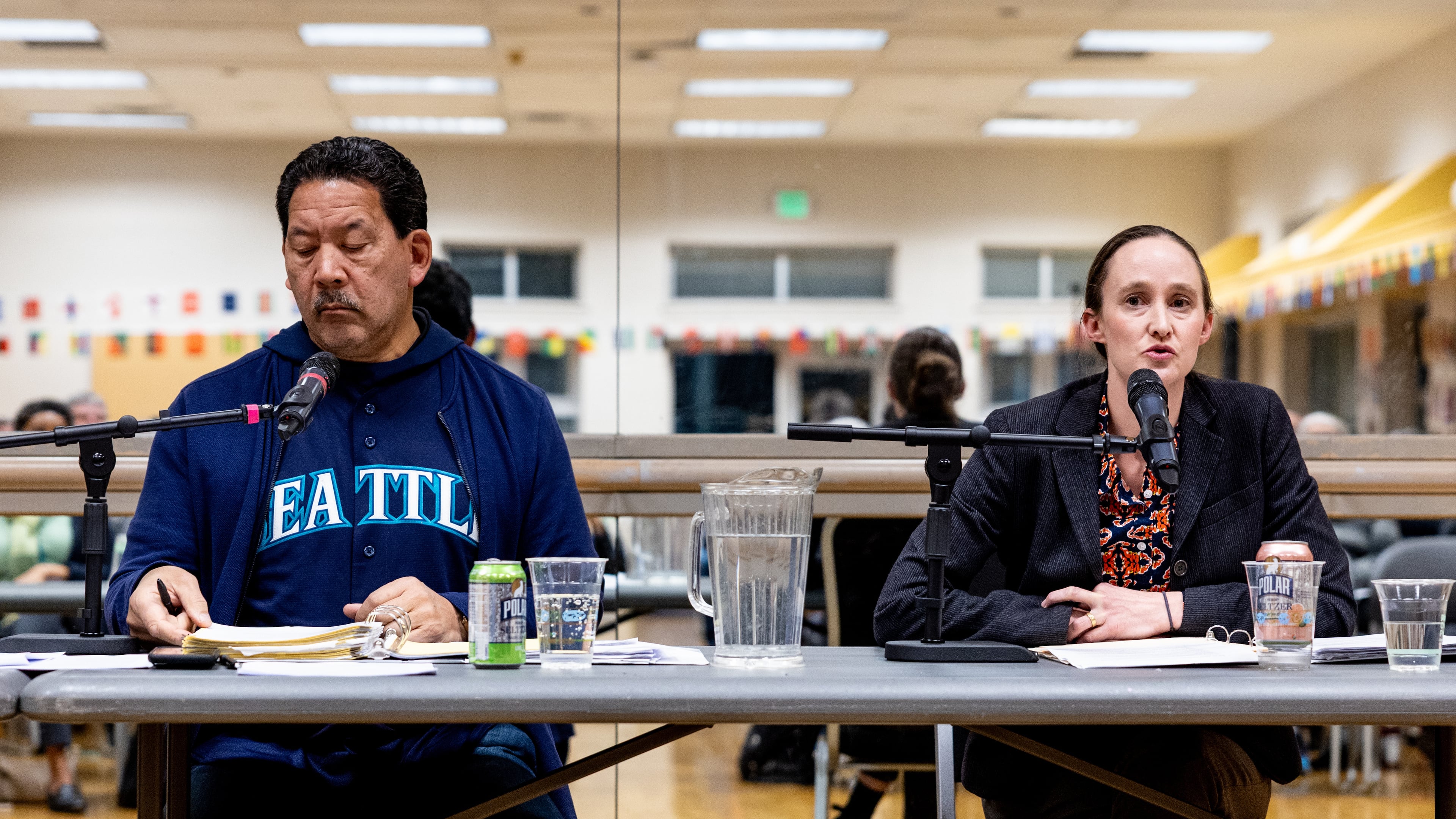 Seattle mayor Bruce Harrell, left, listens as mayoral candidate Katie Wilson, right, speaks during a climate forum Thursday, Oct. 16, 2025, in Seattle. (AP Photo/Maddy Grassy)