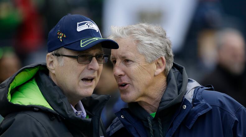 Seattle Seahawks owner Paul Allen, left, talks to head coach Pete Carroll before the 2015 NFC Championship game against the Green Bay Packers in Seattle.