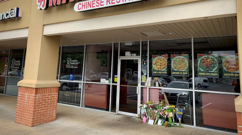 Regular customers and family friends placed flowers in front of the shuttered Main Moon restaurant a day after one of its owners was killed when a large appliance exploded in the restaurant's kitchen.