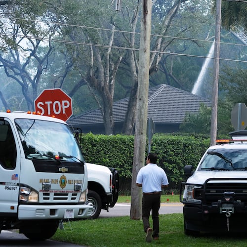 Firefighters work to extinguish the remains of a fire at a home owned by Miami Heat basketball coach Erik Spoelstra, Thursday, Nov. 6, 2025, in Miami. (AP Photo/Rebecca Blackwell)