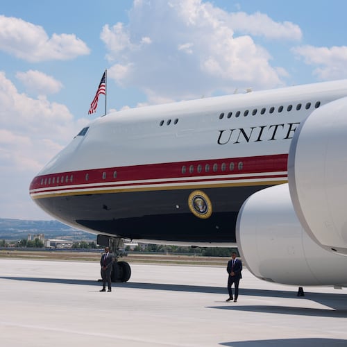 Staff lay a carpet on the tarmac before President Donald Trump exits Air Force One upon arriving for the NATO summit in Ankara, Turkey, Tuesday, July 7, 2026. (AP Photo/Alex Brandon)