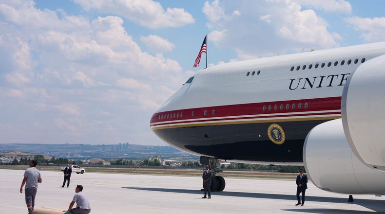 Staff lay a carpet on the tarmac before President Donald Trump exits Air Force One upon arriving for the NATO summit in Ankara, Turkey, Tuesday, July 7, 2026. (AP Photo/Alex Brandon)