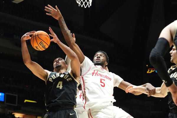 Purdue's Trey Kaufman-Renn (4) and Houston's Ja'Vier Francis (5) reach for a rebound during the first half in the Sweet 16 of the NCAA college basketball tournament Friday, March 28, 2025, in Indianapolis. (AP Photo/Michael Conroy)