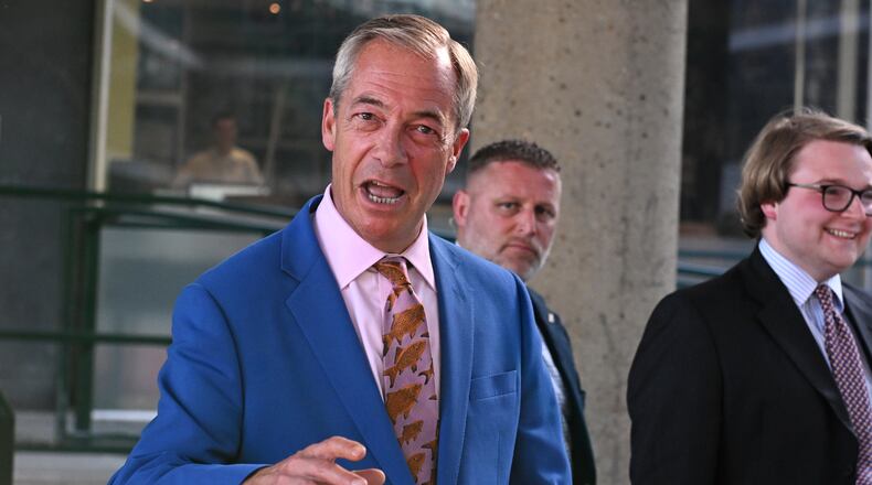 Britain's Reform UK leader Nigel Farage leaves Milbank Tower after he said he'll quit his Parliament seat and seek reelection in London, Tuesday, July 7, 2026.(AP Photo/Thomas Krych)