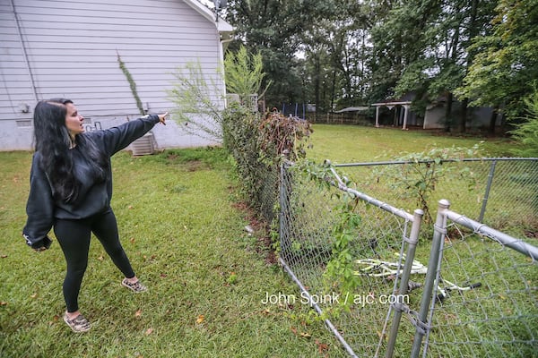 Brittney Speck points to the area where her dog was attacked by a tiger on the loose in Henry County. JOHN SPINK / JSPINK@AJC.COM