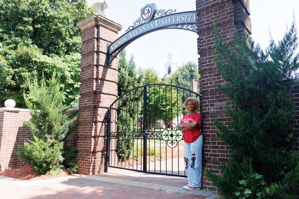 Anjelina Bridges, a senior at Clark Atlanta University, stands outside the gates of Clark Atlanta University on Friday, July 31, 2026, in Atlanta. She believes Black men who are choosing not to attend an HBCU are missing out on brotherhood and emotional openness. (Estela Muñoz/AJC)