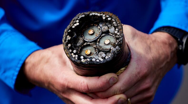 FILE - Burke Hales, chief scientist for the PacWave wave energy test site overseen by Oregon State University, shows the electric cables that are buried under the seabed near Newport, Ore., Aug. 23, 2024. (AP Photo/Craig Mitchelldyer, File)