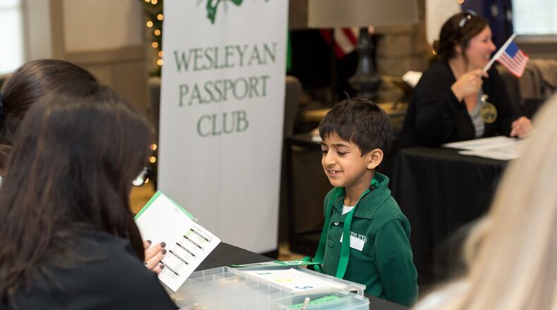 Wesleyan School student Sal Agarwal answers questions about countries he’s learned through the Passport Club, a program that promotes the study of countries around the globe. Students who master the material receive passport stamps and points they can redeem at a year-end bazaar. Photo courtesy of Wesleyan School.
