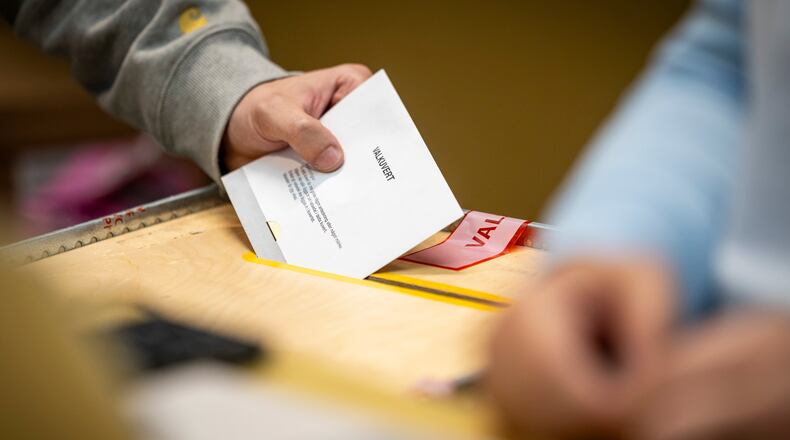 A ballot envelope is placed in a ballot box at a polling station at the City Hall in Malmo, Sweden, Sunday, Sept. 13, 2026. (Johan Nilsson/TT News Agency via AP)