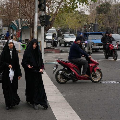 Women cross an intersection in downtown Tehran, Iran, Thursday, Jan. 15, 2026. (AP Photo/Vahid Salemi)