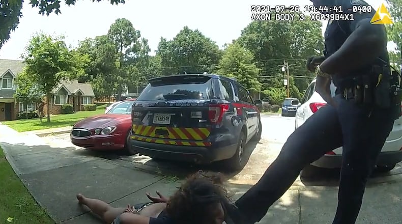 Body camera footage captures Atlanta Sgt. Marc Theodule kicking a woman in the face as they wait for an ambulance to transport her for emergency mental health treatment on July 26, 2021. The woman repeatedly spit toward the sergeant while she was handcuffed and on the ground. (Atlanta Police Department)
