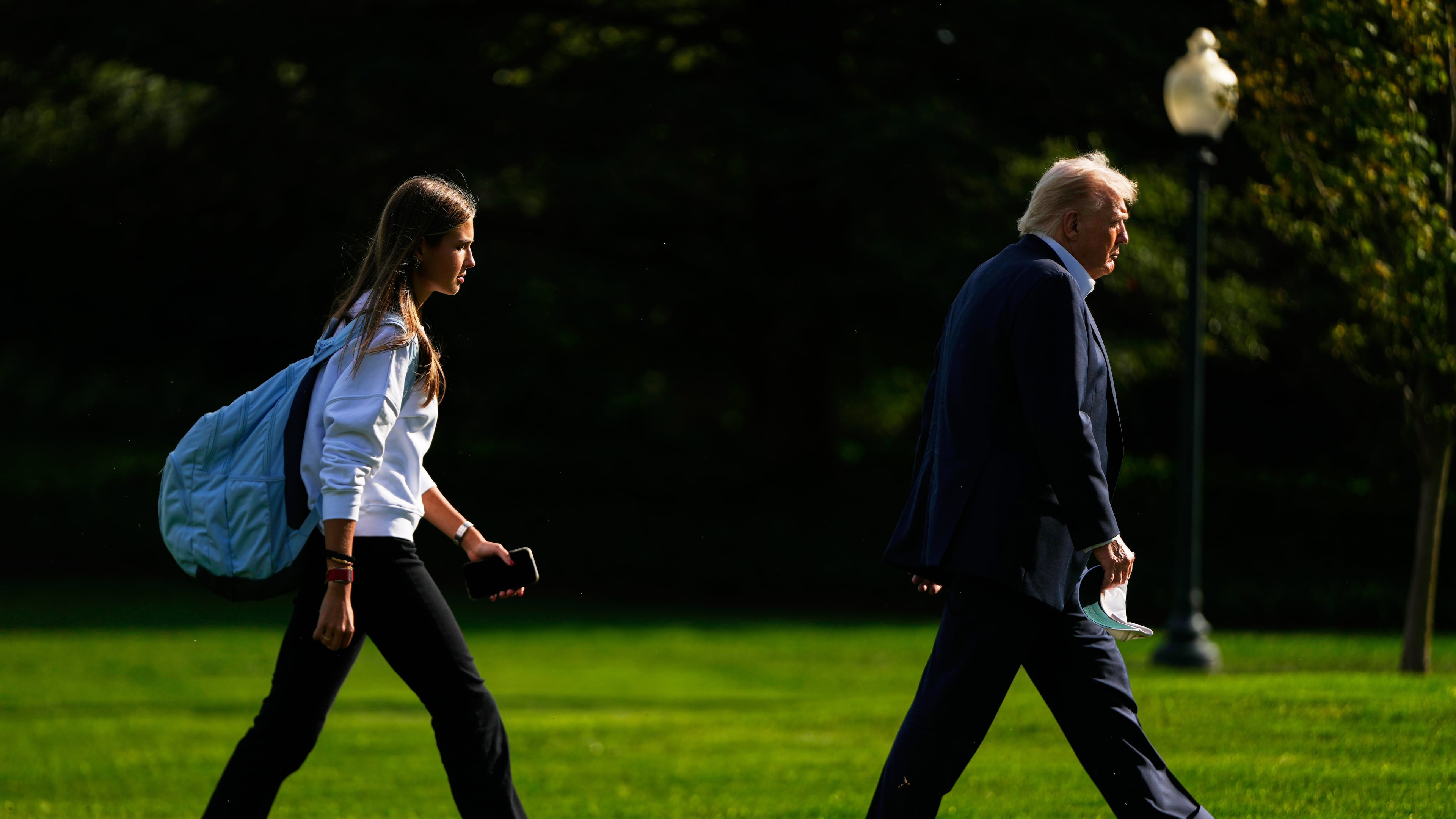 FILE - President Donald Trump, right, arrives with his granddaughter Kai Trump at the White House, Friday, Sept. 26, 2025, in Washington. (AP Photo/Julia Demaree Nikhinson, file)