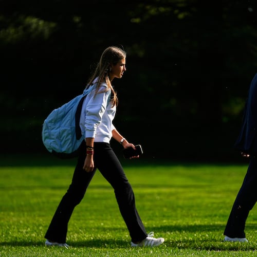 FILE - President Donald Trump, right, arrives with his granddaughter Kai Trump at the White House, Friday, Sept. 26, 2025, in Washington. (AP Photo/Julia Demaree Nikhinson, file)