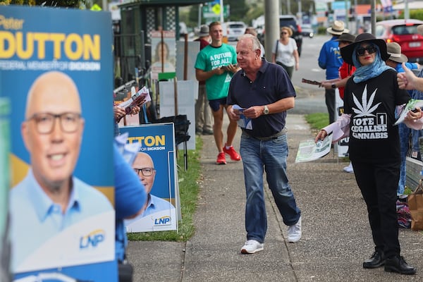 A man walks into a polling station in Brisbane, Australia, Saturday, May 3, 2025. (AP Photo/Pat Hoelscher)