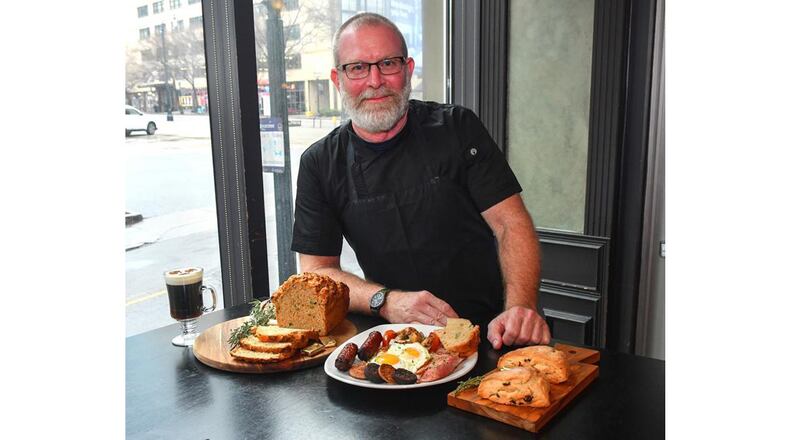 Fadó Irish Pub corporate chef Bryan McAlister poses with (from left) Fadó Irish Coffee, Fadó Guinness Cheddar Bread, Fadó Irish Breakfast and Fadó Cranberry-Thyme Scones. STYLING BY BRYAN MCALISTER / CONTRIBUTED BY CHRIS HUNT PHOTOGRAPHY