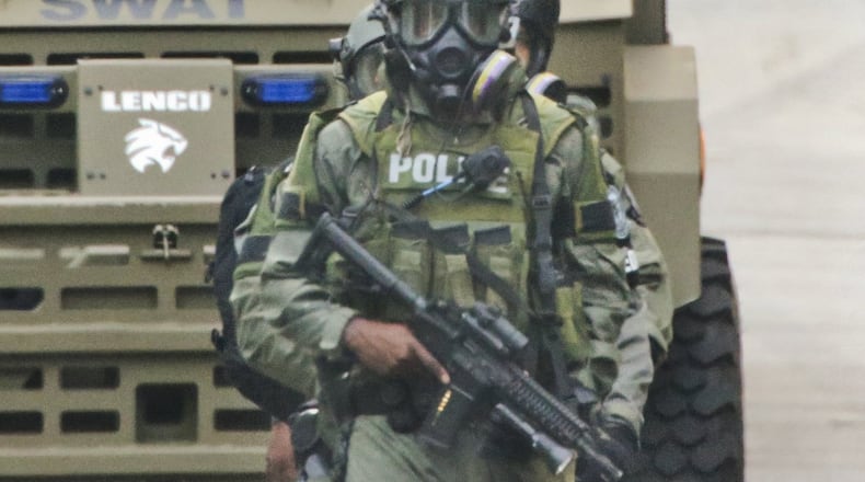 Atlanta police surrounded a home in southwest Atlanta — Zone 3 for city police — for several hours in June, but when SWAT officers went into the house, the person whey were looking for was not there. They did recover three rifles and a revolver. JOHN SPINK/JSPINK@AJC.COM