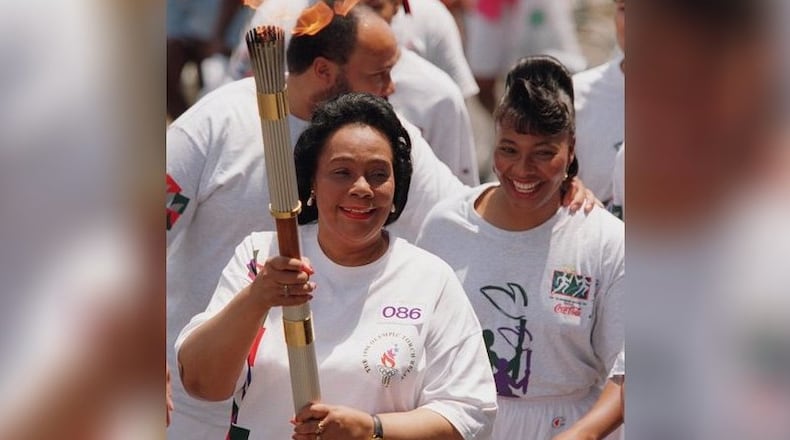 Coretta Scott King (with daughter Bernice King and son Martin Luther King III by her side) carries the Olympic torch prior to the start of the 1996 Olympic Games in Atlanta.