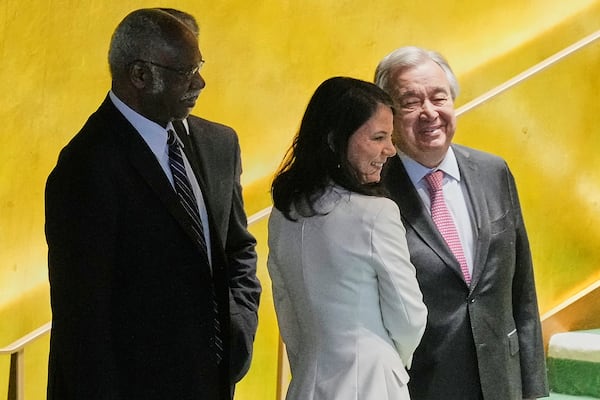 Annalena Baerbock of Germany, center, is greeted by UN Secretary General Antonio Guterres, right, and current UNGA President Philemon Yang, left, after she was elected as president of the 80th session of the UN General Assembly, Monday, June 2, 2025. (AP Photo/Richard Drew)