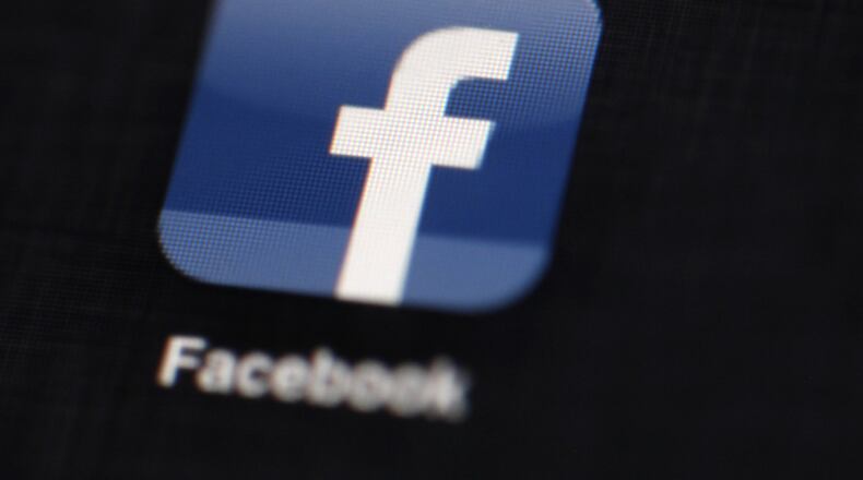 FILE - This May 16, 2012 file photo shows the Facebook logo displayed on an iPad in Philadelphia. More Americans check Facebook daily than read the Bible every day. Much more, by more than a three-to-one margin. As Facebook celebrates its 10th anniversary, the numbers it generates are epic. Facebook says worldwide it has 757 million daily active users. Of those 19 percent are in the U.S. and Canada, so that’s more than 143 million people checking Facebook daily in America. (AP Photo/Matt Rourke, File)