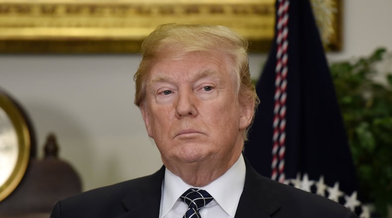 President Donald Trump looks on before signing a proclamation to honor Martin Luther King Jr. Day during a event Friday in the Roosevelt Room of the White House. Trump is under fire after reports he used a derogatory phrase to refer to Haiti and African countries. OLIVIER DOULIERY / ABACA PRESS / TNS