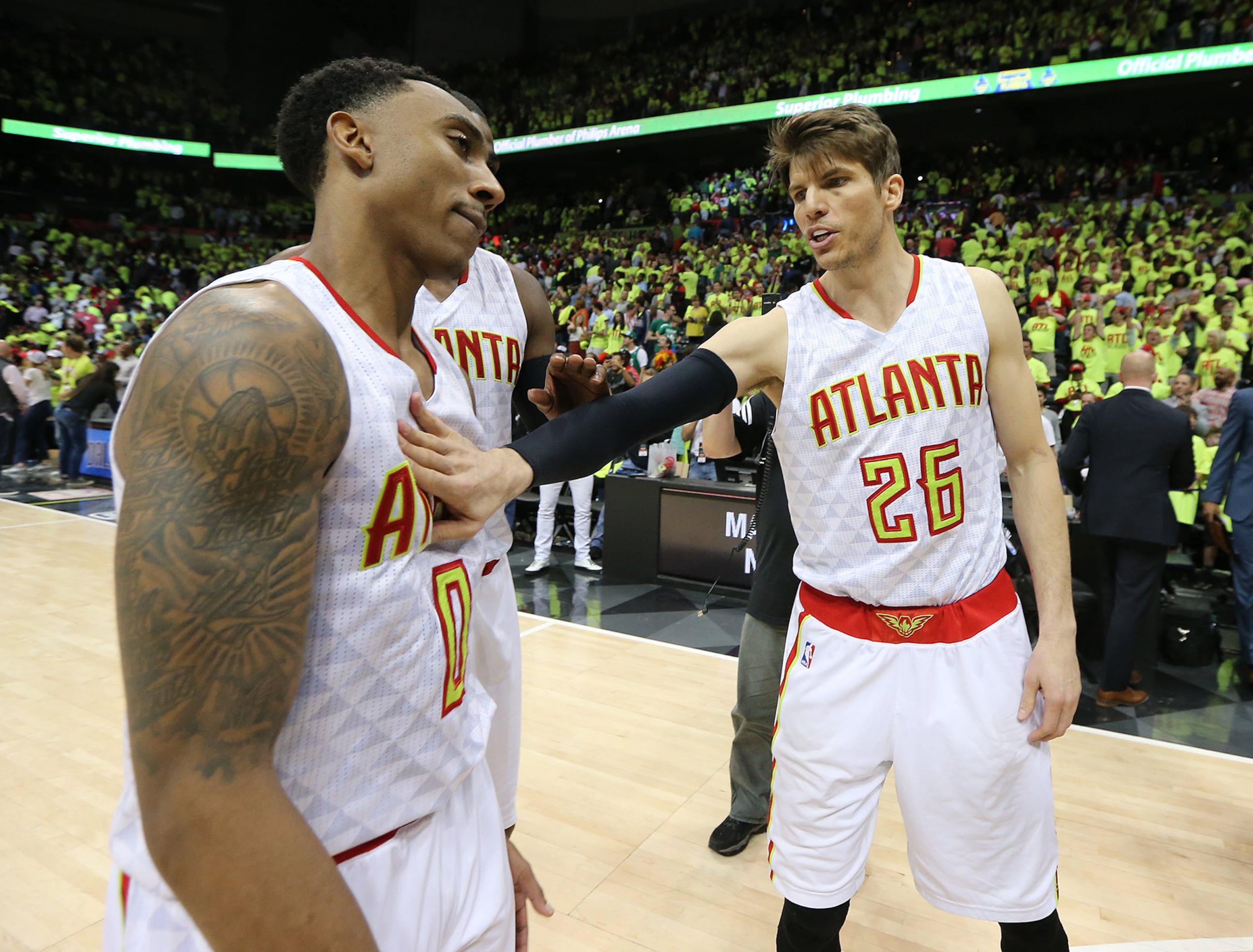 Jeff Teague (left) gets a pat on the chest from Kyle Korver as the Hawks beat the Celtics 102-101 in Game 1 of their NBA Eastern Conference first round playoff game at Philips Arena on Saturday, April 16, 2016. (Curtis Compton/AJC)
