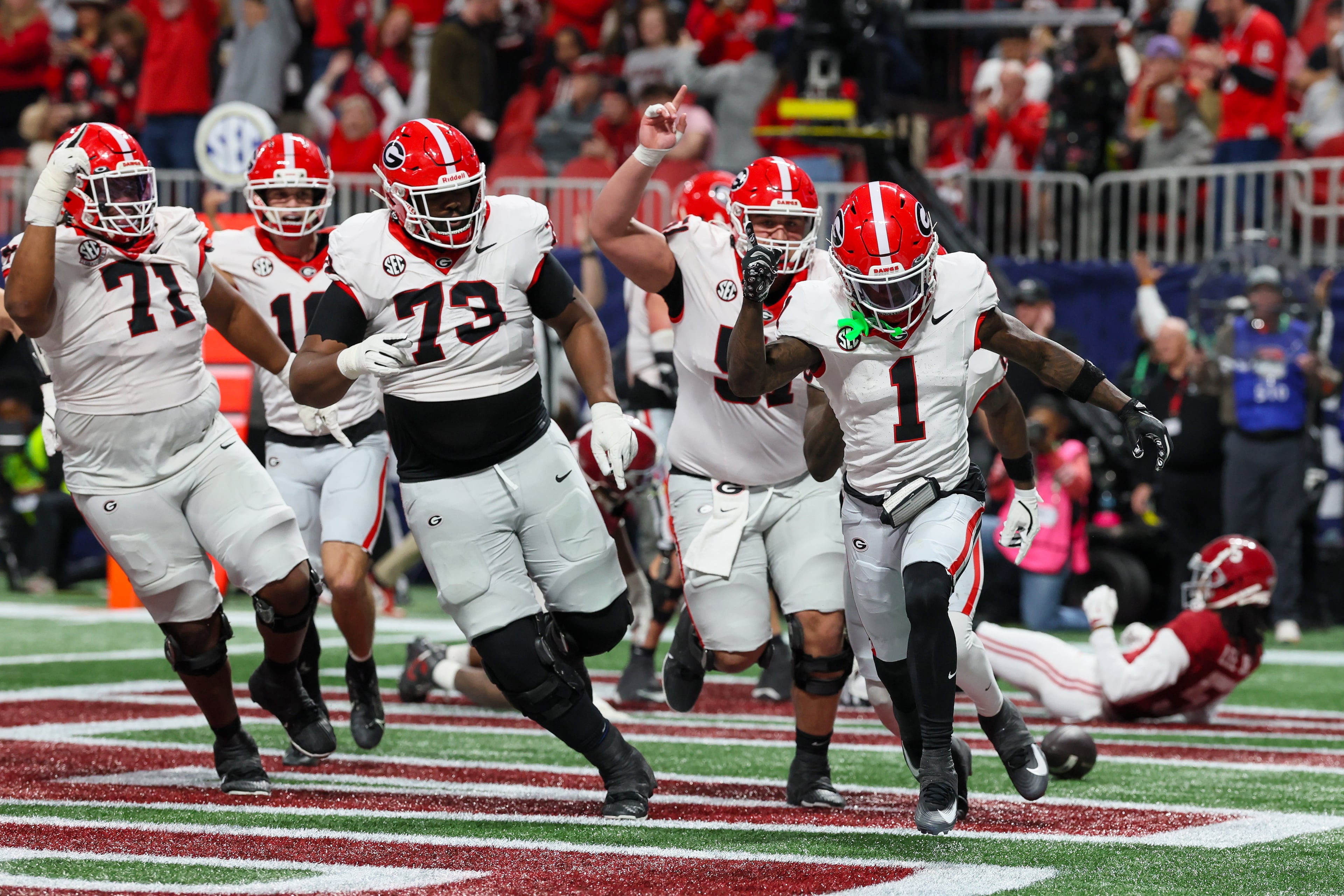 Georgia wide receiver Zachariah Branch (1) reacts after scoring a touchdown against Alabama during the fourth quarter of the SEC Championship game at Mercedes-Benz Stadium, Saturday, Dec. 6, 2025, in Atlanta. (Jason Getz / AJC)