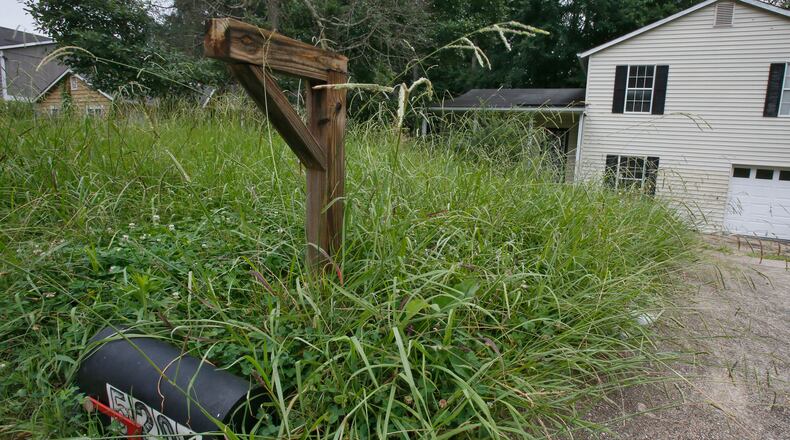 July 26, 2013 - Dekalb County- A vacant house in the Scarbrough Square subdivision near Covington Highway. After years of watching property tax revenue decline and expenses related to foreclosures rise in the wake of an epic real estate meltdown, a host of Georgia counties are looking for someone to blame and pay damages. In a series of lawsuits filed over the last year, Fulton, Gwinnett, DeKalb, Cobb and other Georgia counties have targeted the federal loan guarantee agencies Fannie Mae and Freddie Mac, which they say have illegally avoided real estate filing taxes and fees associated with foreclosures. BOB ANDRES / BANDRES@AJC.COM